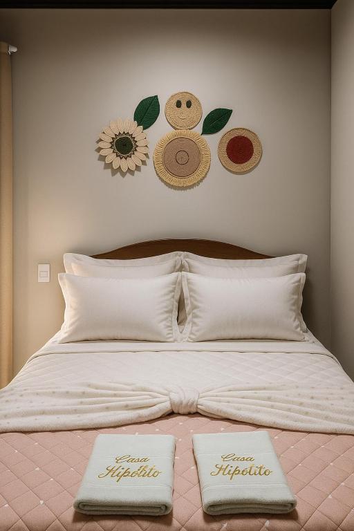 a bed with two pillows on top of it at Loft Hipolito in Belém
