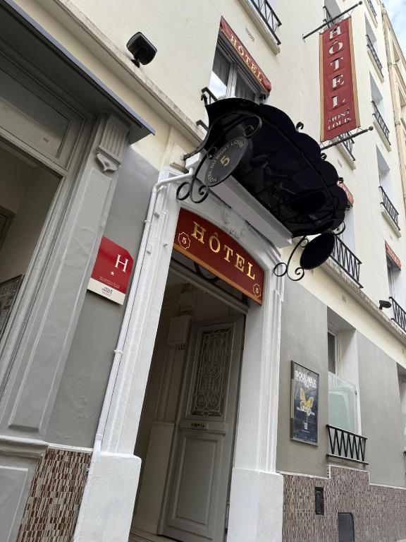 a hotel sign over the door of a building at HOTEL DU MONT LOUIS in Paris