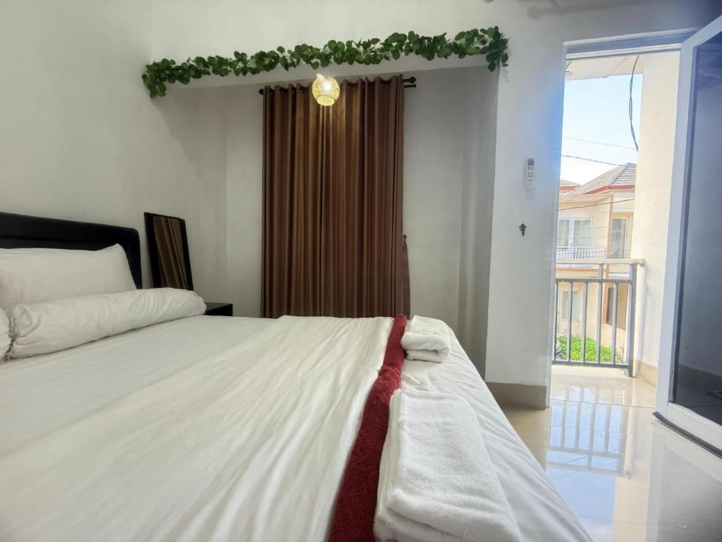 a bedroom with a bed with a christmas garland on it at Private Villa Near Nusa Dua Beach Bali in Nusa Dua