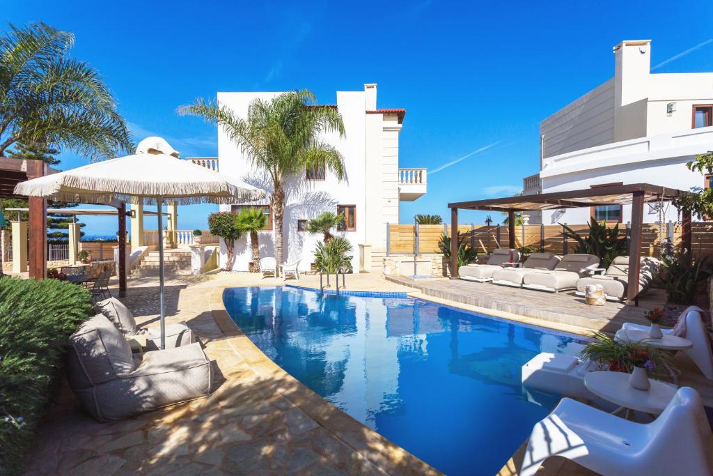 a villa with a swimming pool in front of a building at Sunshine Villa with Private Pool by Estia in Hersonissos