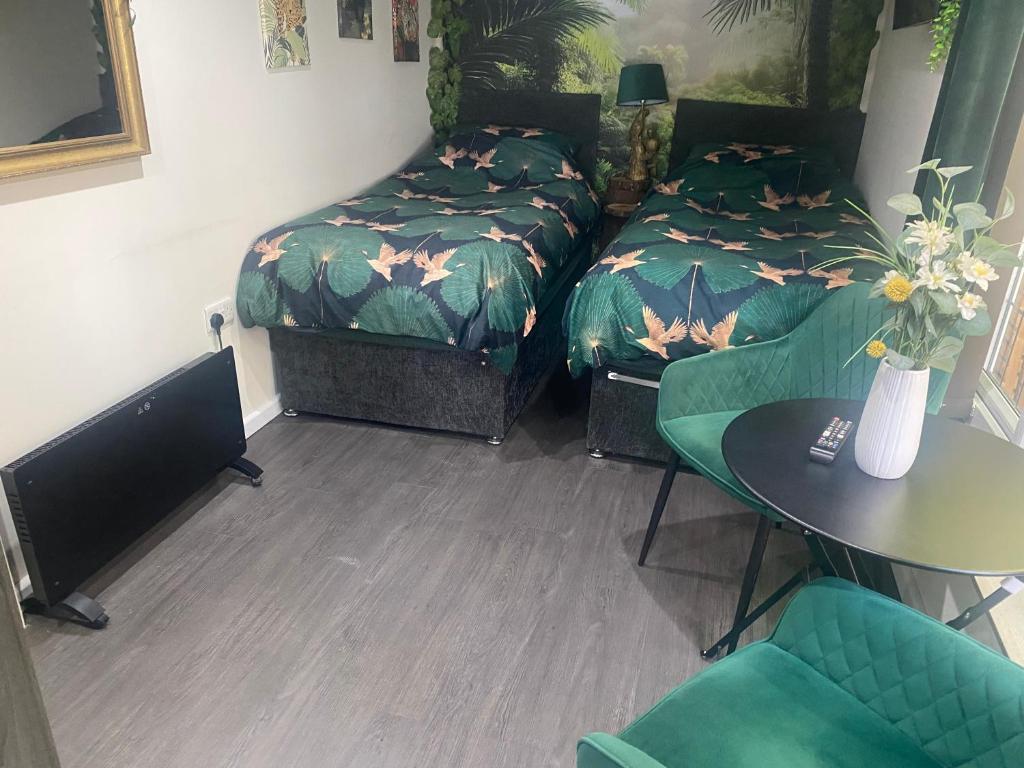 a room with a bed and a table and chairs at Jungle Lodge in Rustington