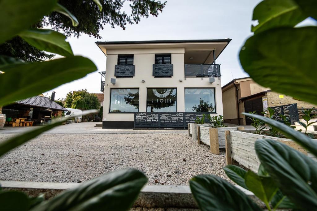 a building with a sign on the front of it at San Marco - Na Brněnské ulici in Mutěnice
