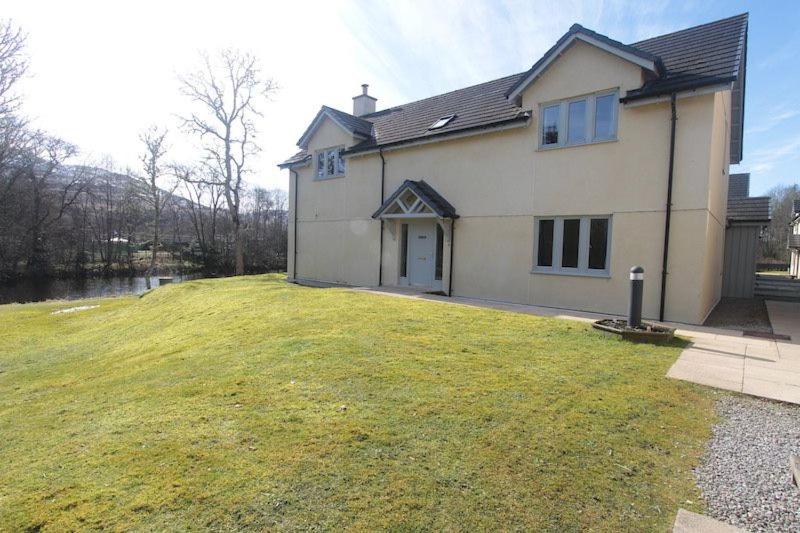 a house with a large lawn in front of it at Cottage 7 - Skye Cottage in Fort Augustus