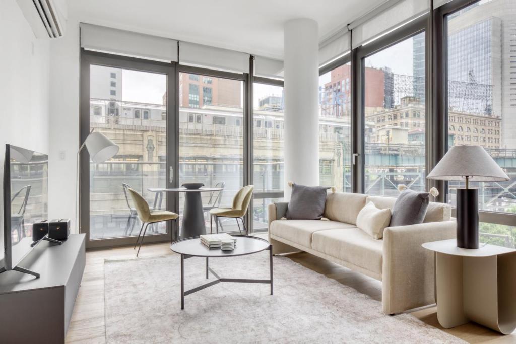 a living room with a couch and a table at LIC 1BR w Gym DM Elevator Private Balcony NYC-768 in Long Island City