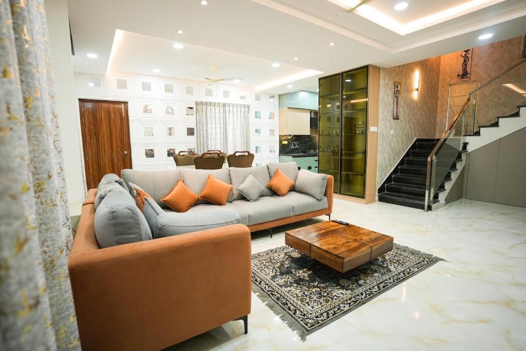 a living room with a couch and a table at Hangout Ville in Hyderabad