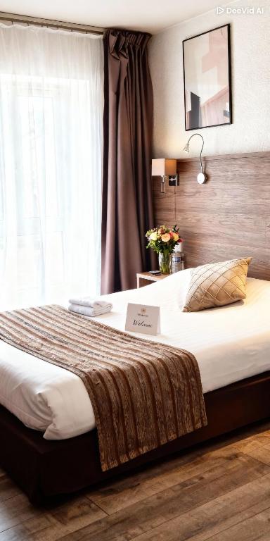a hotel room with a large bed with a sign on it at La Buissonnière in Corbigny