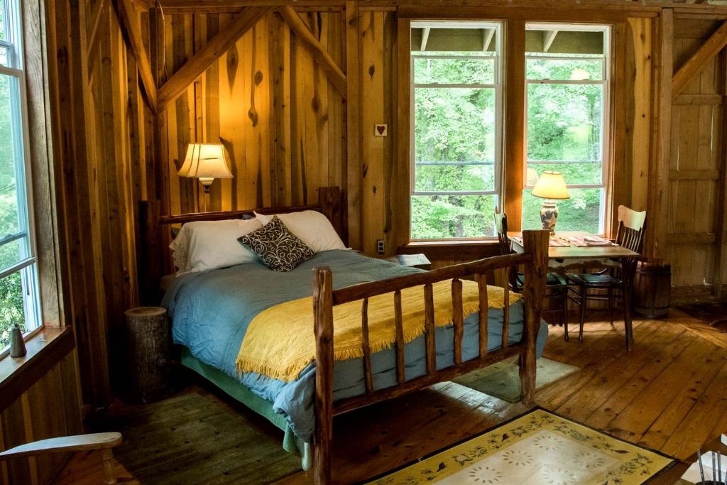 a bedroom with a bed in a room with wooden walls at Charming Vacation Rental in a Barn on a Horse Farm near Afton Mountain in Virginia in Avon