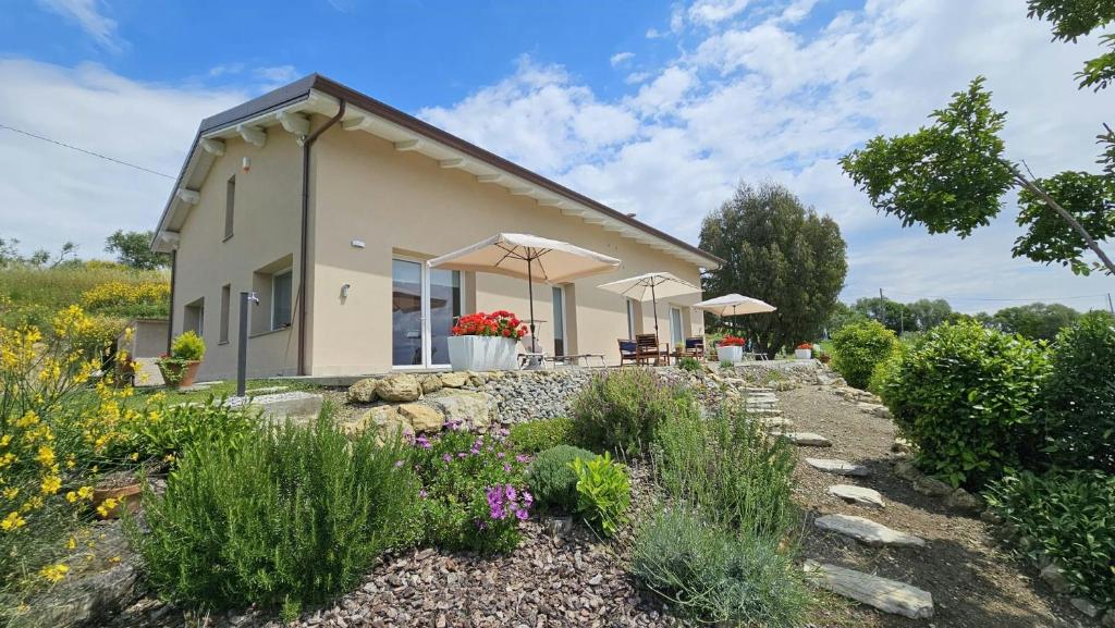a house with a garden in front of it at Panoramic Villa In The Lucca Hills in Capannori