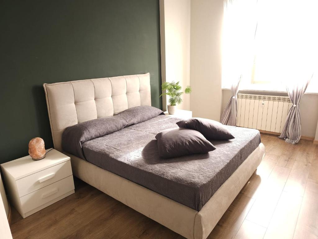 a bedroom with a bed with two pillows on it at vittorino in Turin