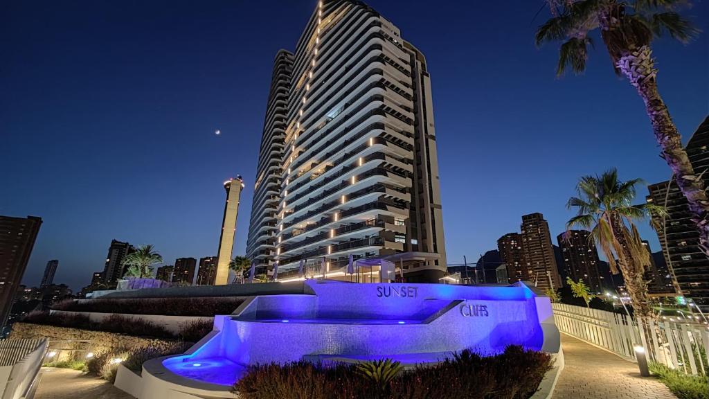a large building with a blue lighting in front of it at SUNSET CLIFFS fantastic apartment in Benidorm