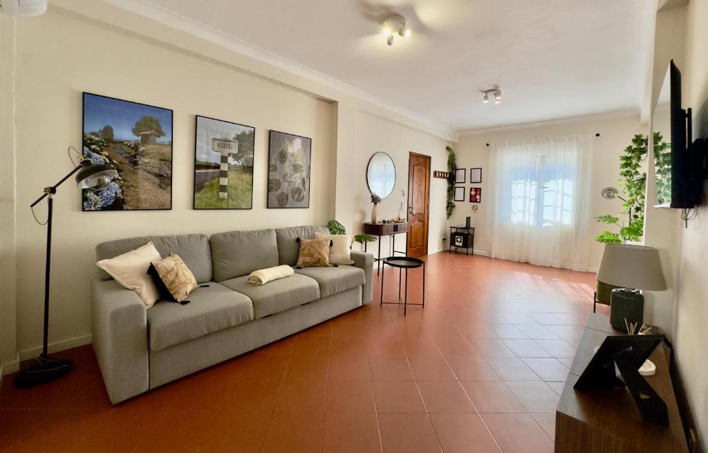 a living room with a couch and a table at Biscoitos-Upstudio in Biscoitos