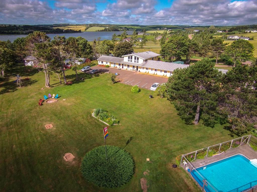 an aerial view of a house and a swimming pool at The Pines Motel and Cottages in Rustico