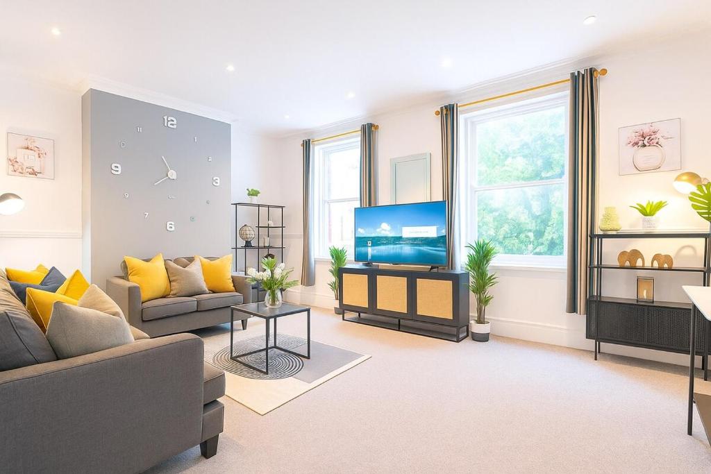 a living room with a couch and a tv at The Lytham Retreat - New! Spacious & Luxurious in Lytham St Annes