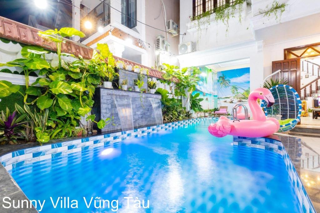 a swimming pool with a pink flamingo in a building at Sunny Villa 109 Võ Thị Sáu in Vung Tau