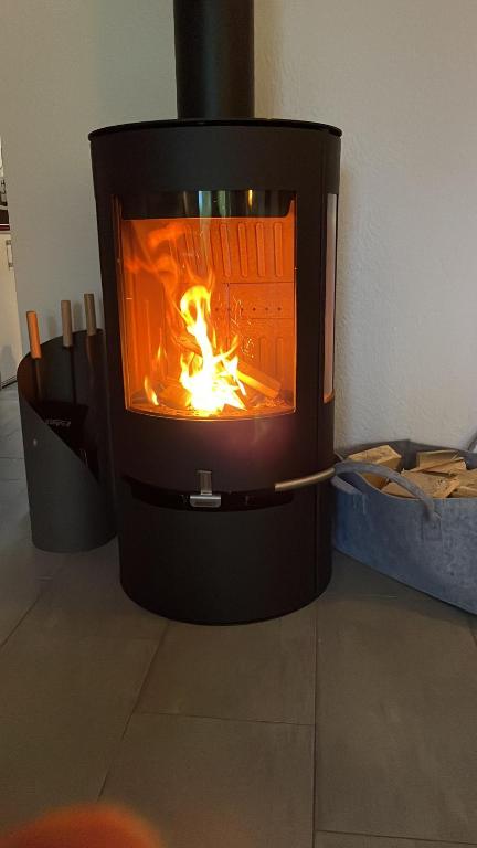 a fireplace with a fire inside of it at Ferienhaus am Nationalpark, Klausdorf, ca 250m bis zur Badestelle in Klausdorf Mecklenburg Vorpommern