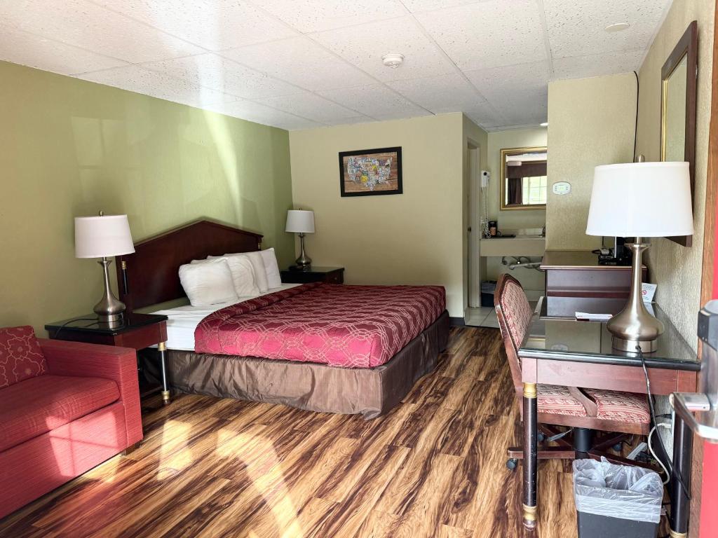 a hotel room with a bed and a couch at Kiteville Bradford in Bradford