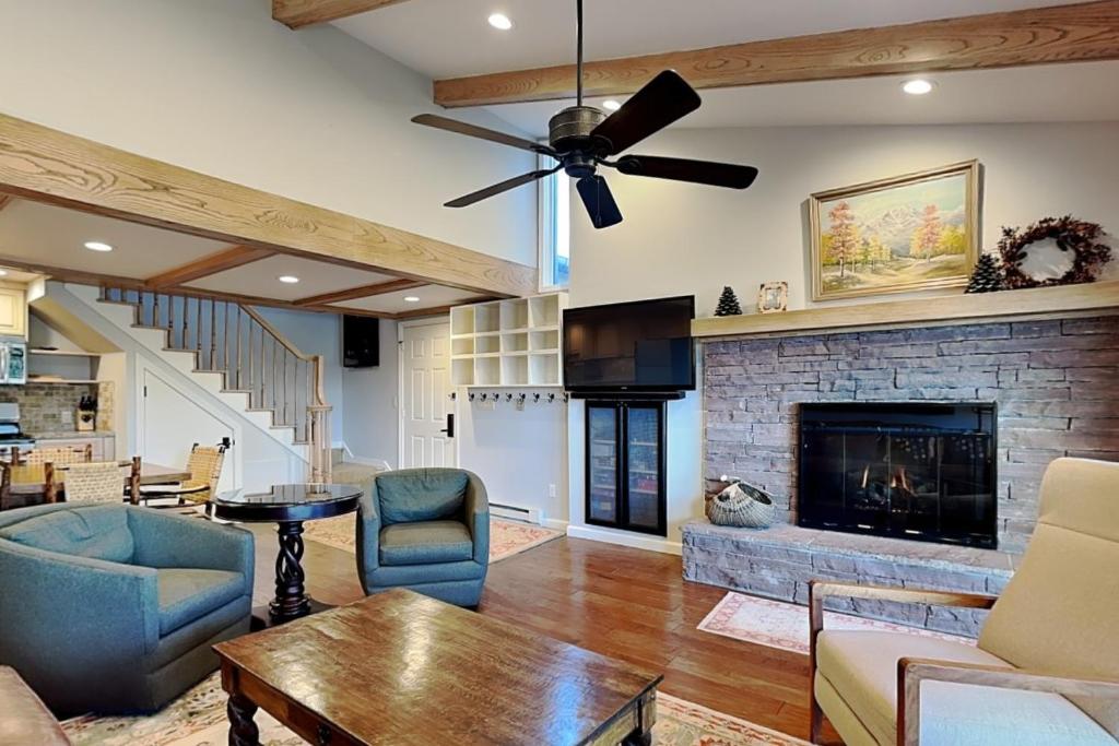 a living room with a fireplace and a ceiling fan at Timberline Condominiums 2 Bedroom plus Loft 3 Bath Deluxe Unit D3D in Snowmass Village