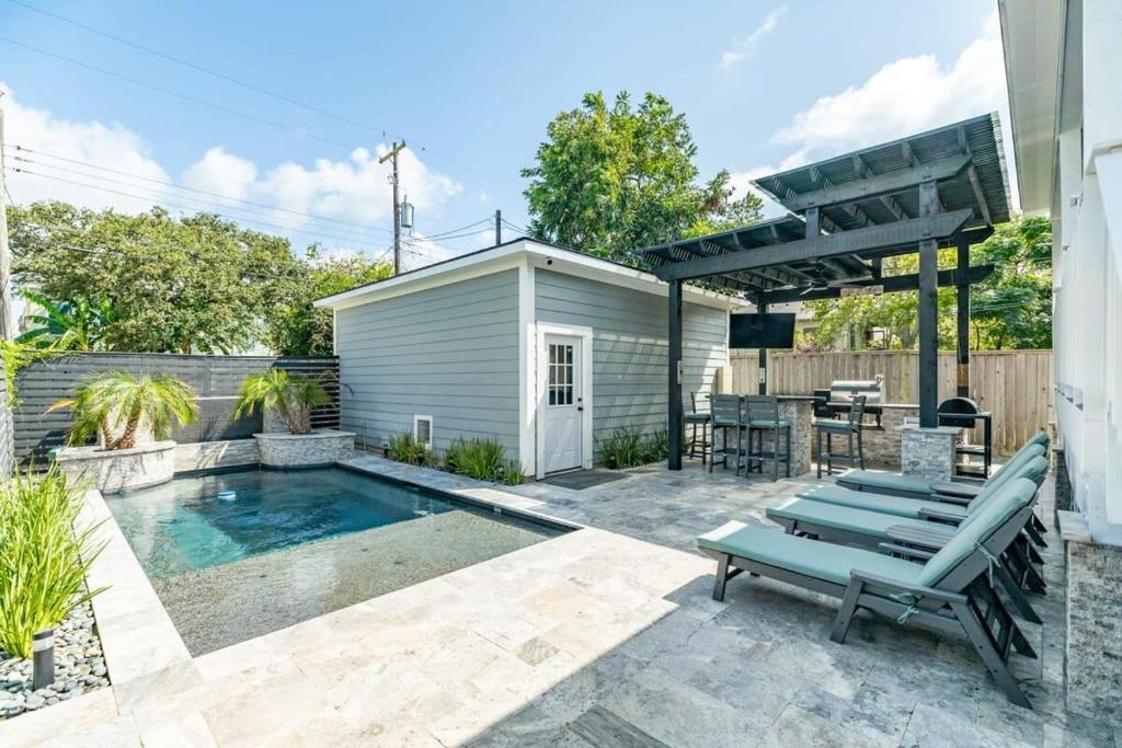 a backyard with a swimming pool and a picnic table at Exudes the Posh Life Heated Pool Fireplace & Stunning in Galveston