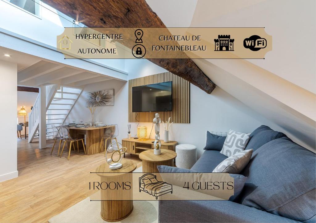 a living room with a blue couch and a loft at Le Duplex du Château – Fontainebleau Centre in Fontainebleau