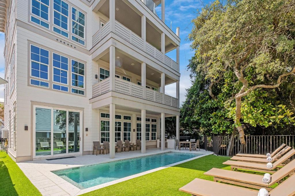 a large house with a swimming pool in the yard at Dogwood Lookout in Seagrove Beach