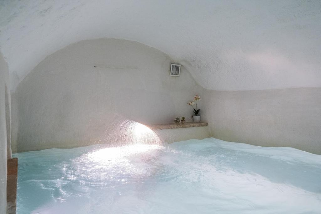 a room with a bed with water in it at Amazing Apartment Alla Corte with pool and sauna in Taurisano
