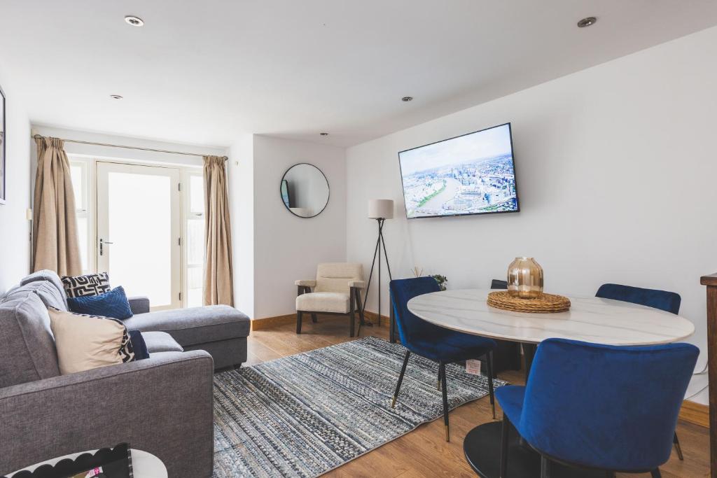 a living room with a couch and a table at Elegant 1BDR Flat with Private Patio in Twickenham