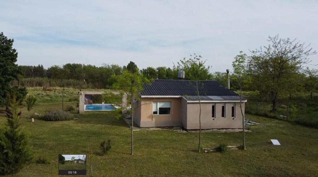 a small house with a solar roof on a field at Cabaña los Robles in Gowland