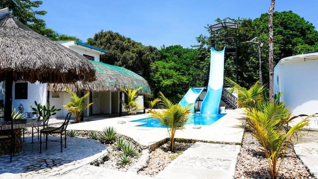 a resort with a water park with a slide at Villa del Atardecer Caribeño - JhonLimar in Bocachica