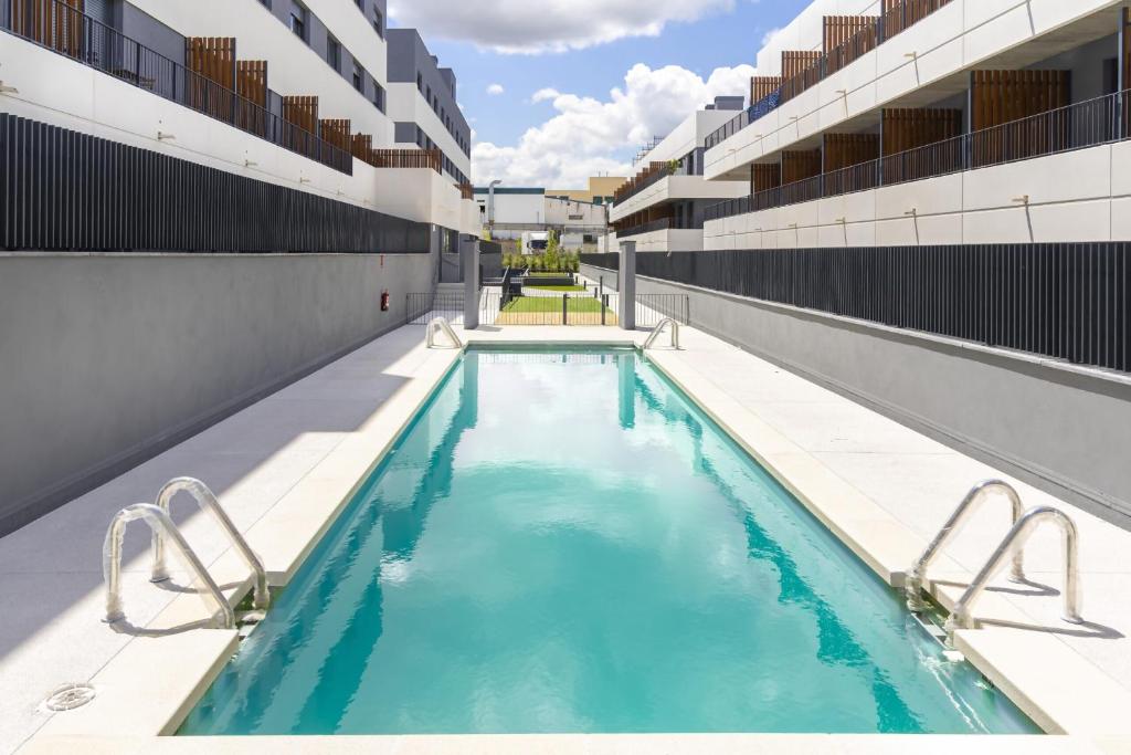 a swimming pool on the side of a building at A&R Atico Duplex Luxury I in San Sebastián de los Reyes