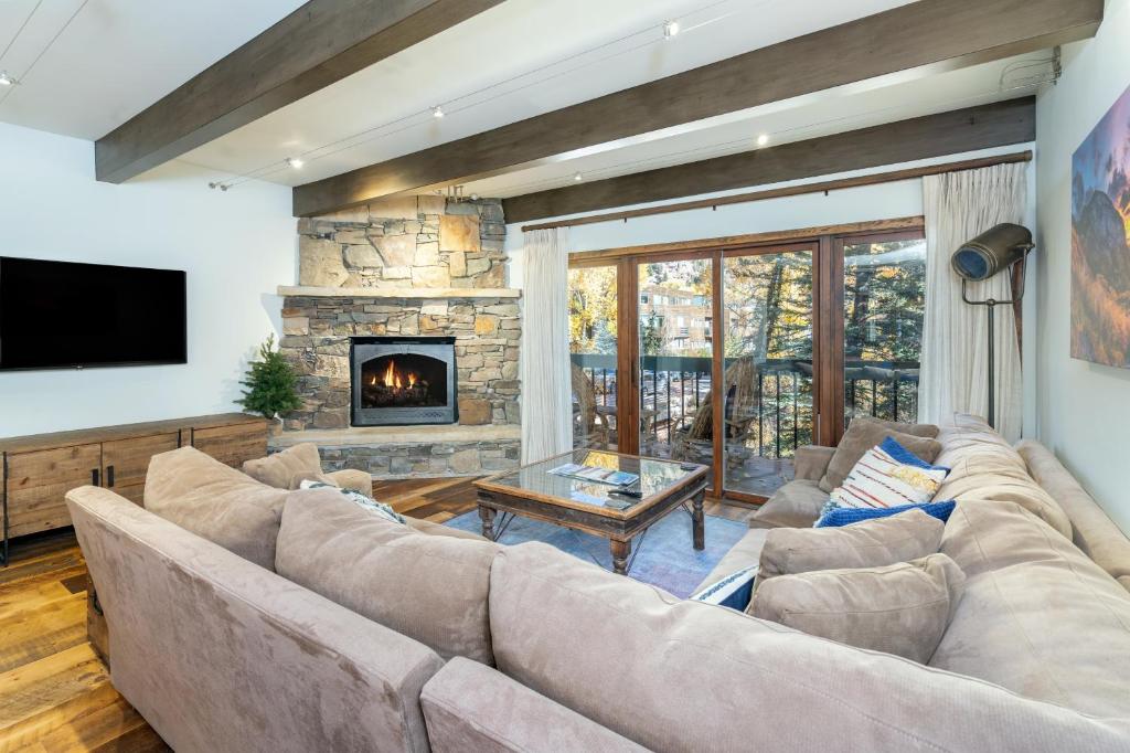 a living room with a couch and a fireplace at Riverside A101 - Riverside Hummingbird in Telluride