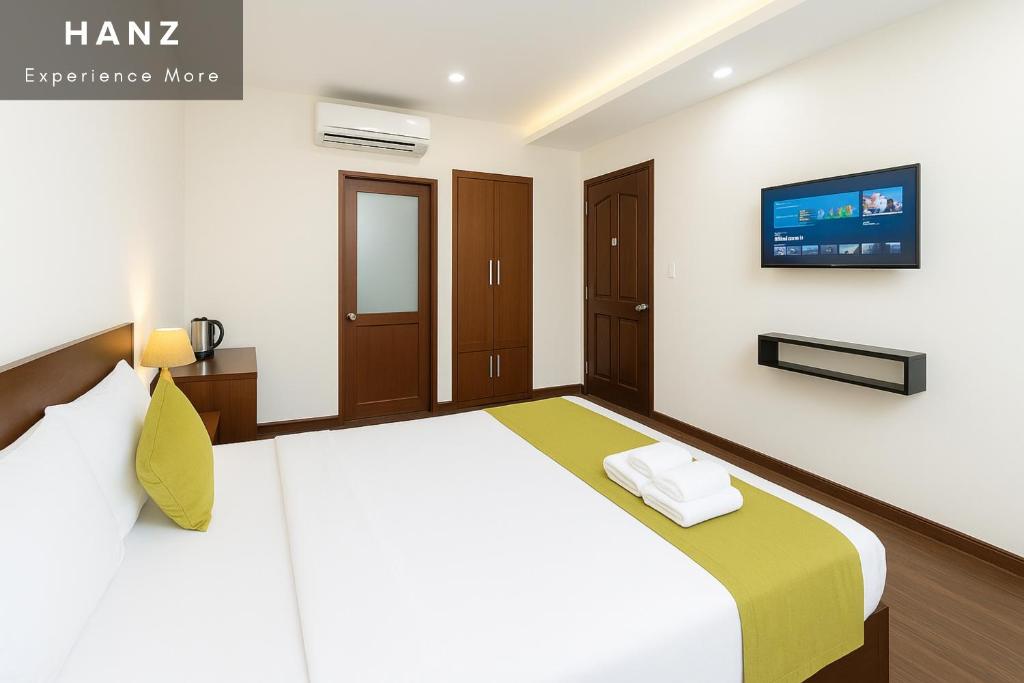 a bedroom with a bed and a tv on the wall at S79 Boutique And Crowne Bui Vien in Ho Chi Minh City