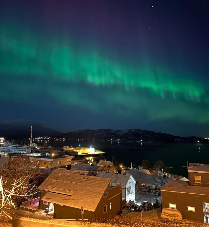 an image of the aurora in the sky over a city at Hjem i Senja in Senja