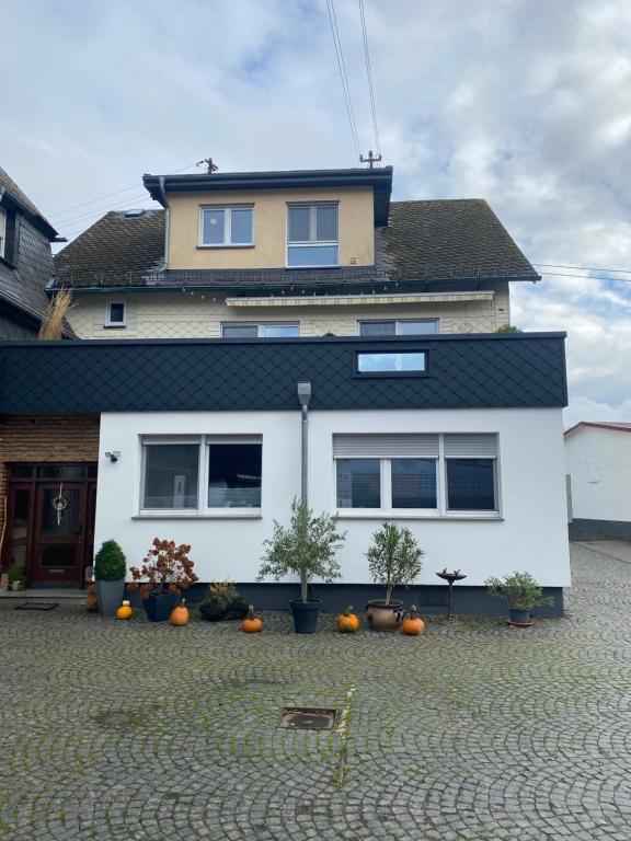 a house with pumpkins in front of it at Ferienwohnung auf dem Bauernhof in Hachenburg Hof Kleeberg I Man kann ein Appartment mit Bad zubuchen in Hachenburg