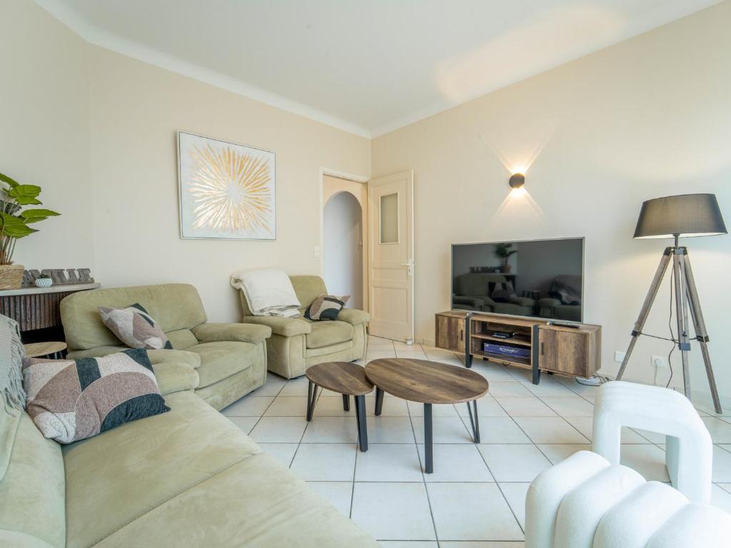 a living room with a couch and a table at Maison rénovée à Mimizan pour 10 pers. avec jardin proche océan - FR-1-50-194 in Mimizan