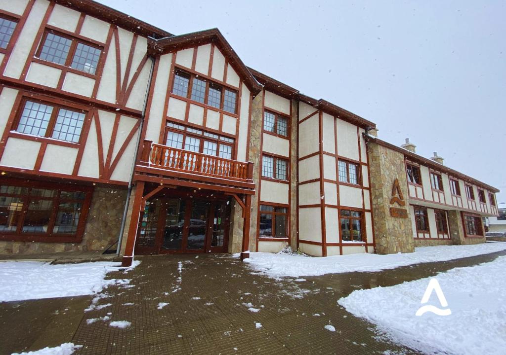 a large building with a balcony in the snow at Almasur Punta Arenas in Punta Arenas