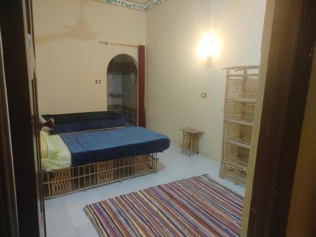 a small room with a bed and a mirror at agyptus camp in Siwa