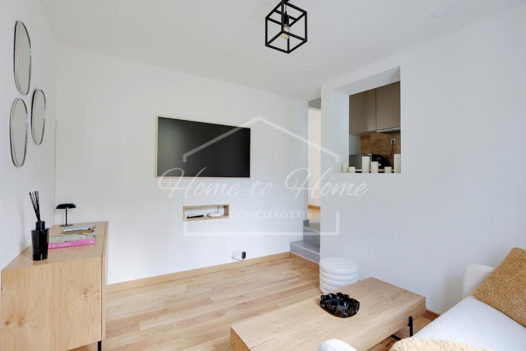 a living room with a couch and a tv at New, Elegant & Cozy, 2 Guests in Bagneux