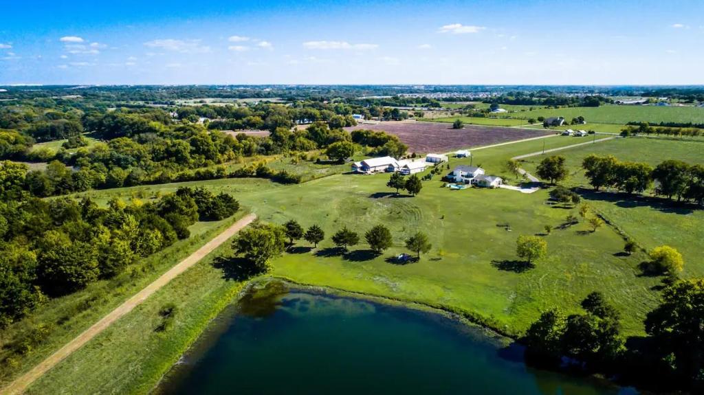 an aerial view of a large estate with a lake at Cottage 2 on Ranch with Fishing & Camping in McKinney