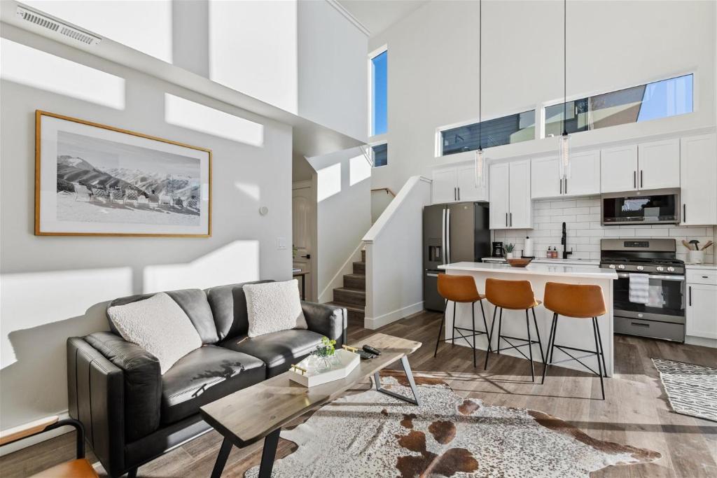 a living room with a couch and a kitchen at Quarry A28 in Whitefish