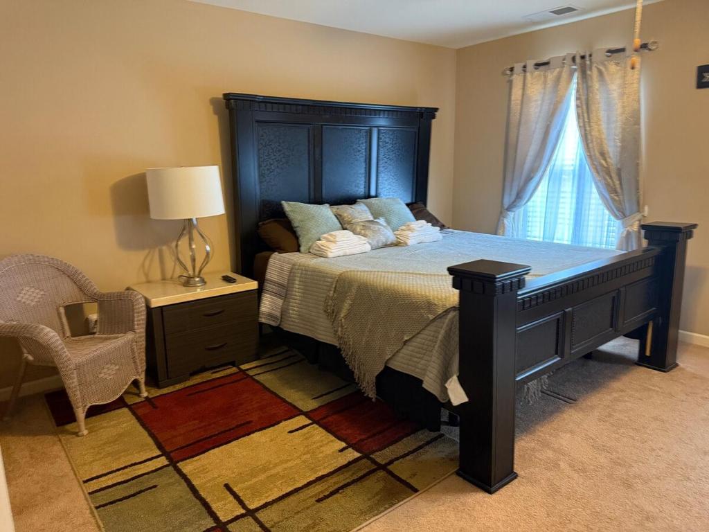 a bedroom with a large bed and a window at Your Lawrenceville home in the heart of it all in Lawrenceville