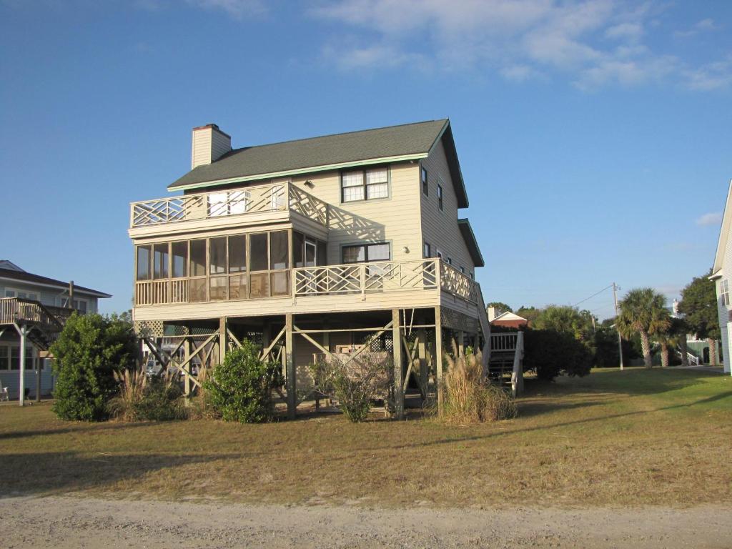 a large house with a large deck on a lawn at Belvedere in Edisto Island