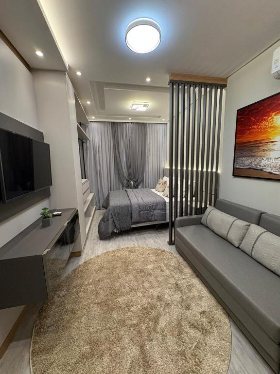 a living room with a couch and a bed at Apartment 403 withoeft in Pomerode