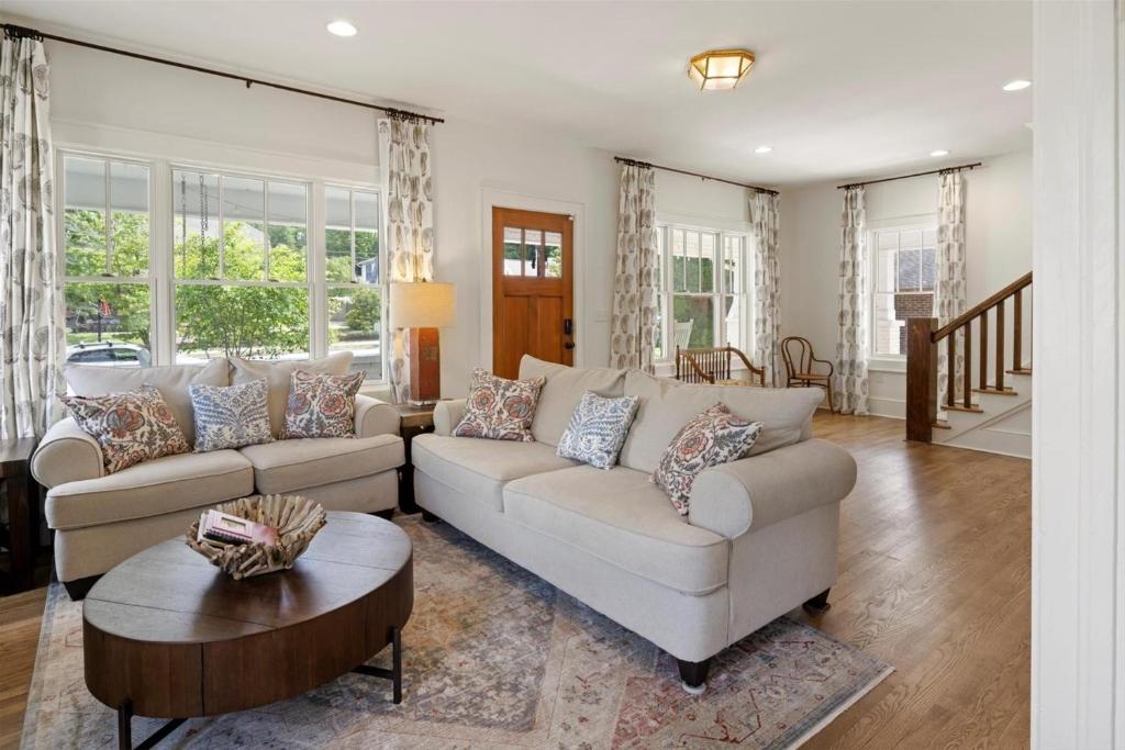 a living room with two couches and a table at Witek Rinker House in Brevard