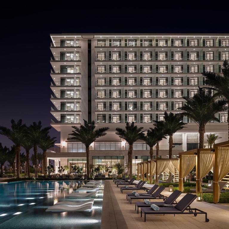 a hotel with a swimming pool at night at Address Marassi Residence, Bahrain in Manama