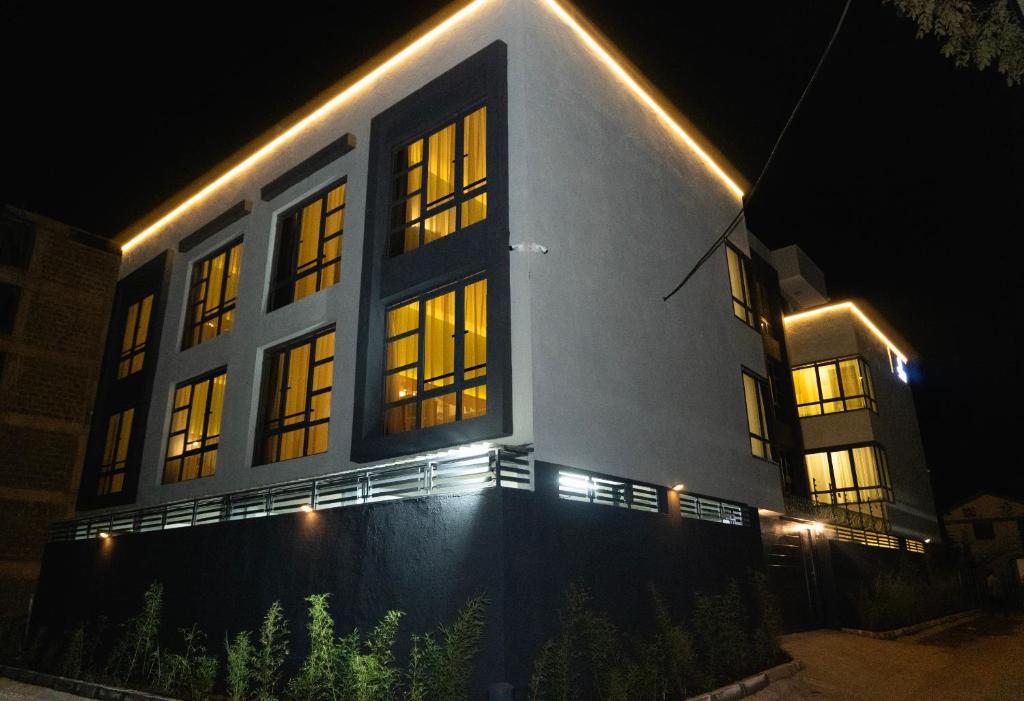 a building with lights on it at night at Amoria Boutique Hotel in Kiambu
