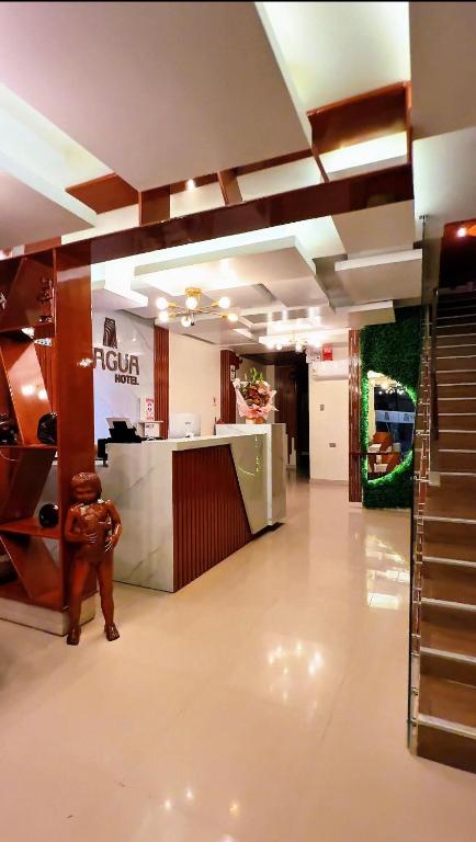 a lobby of a store with a counter and stairs at Hotel Yagua Iquitos in Iquitos