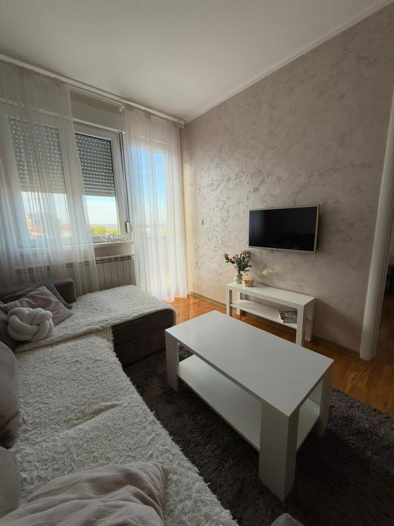 a living room with a couch and a tv at Kutak mira in Belgrade