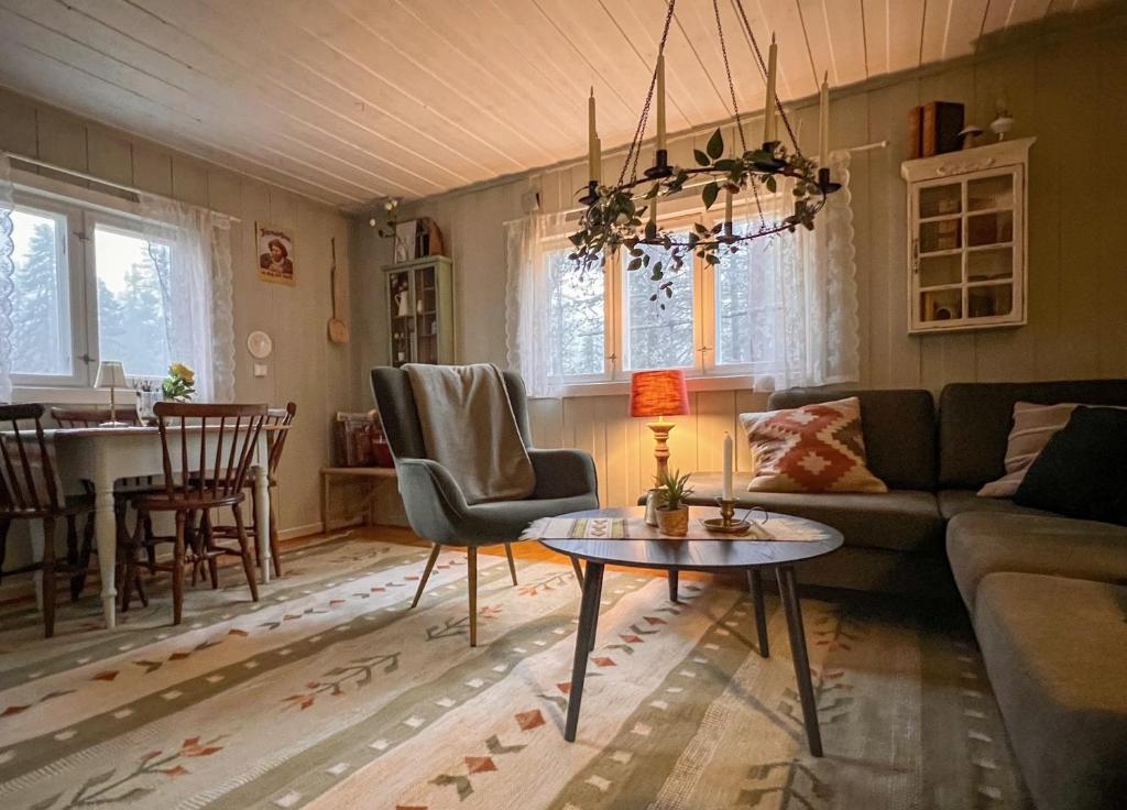 a living room with a couch and a table at Veslekoia - Grandmas Escape in Øksna