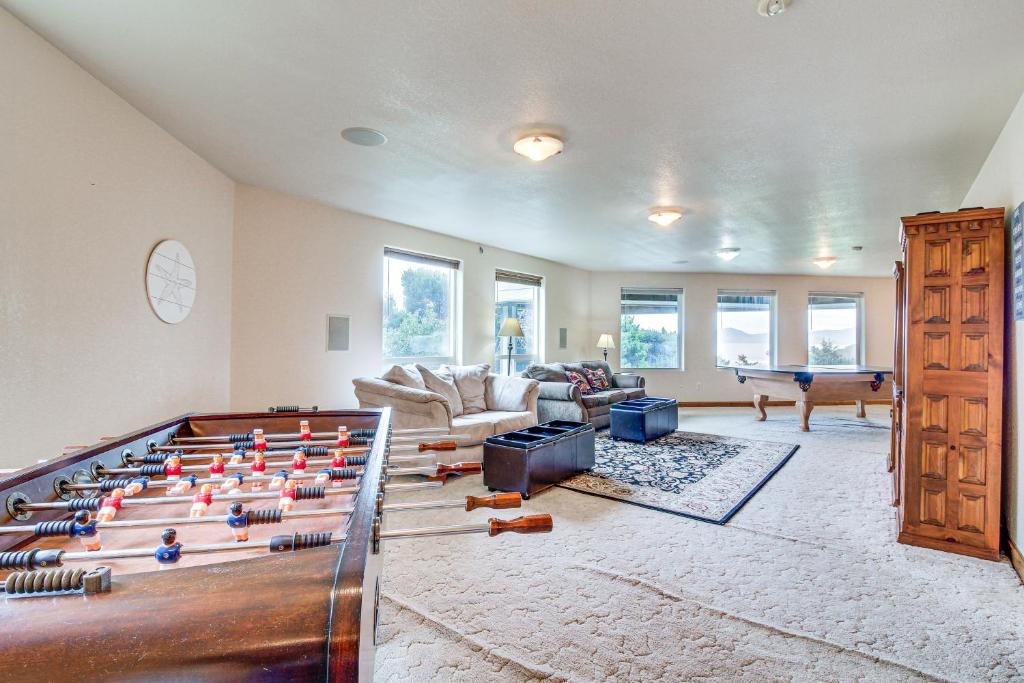 a living room with a pool table in the middle at Groups Welcome! Ocean-View Escape in Gold Beach in Gold Beach