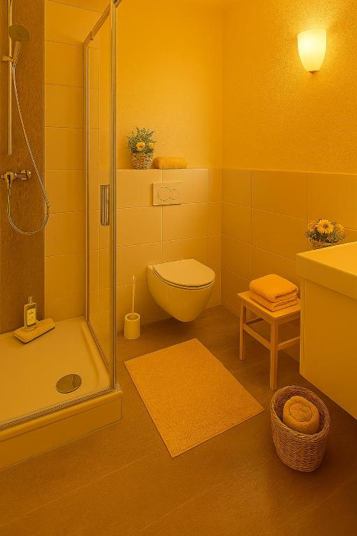 a yellow bathroom with a toilet and a shower at Ferienwohnung Sonnenschein für bis 4 Personen in Bechhofen